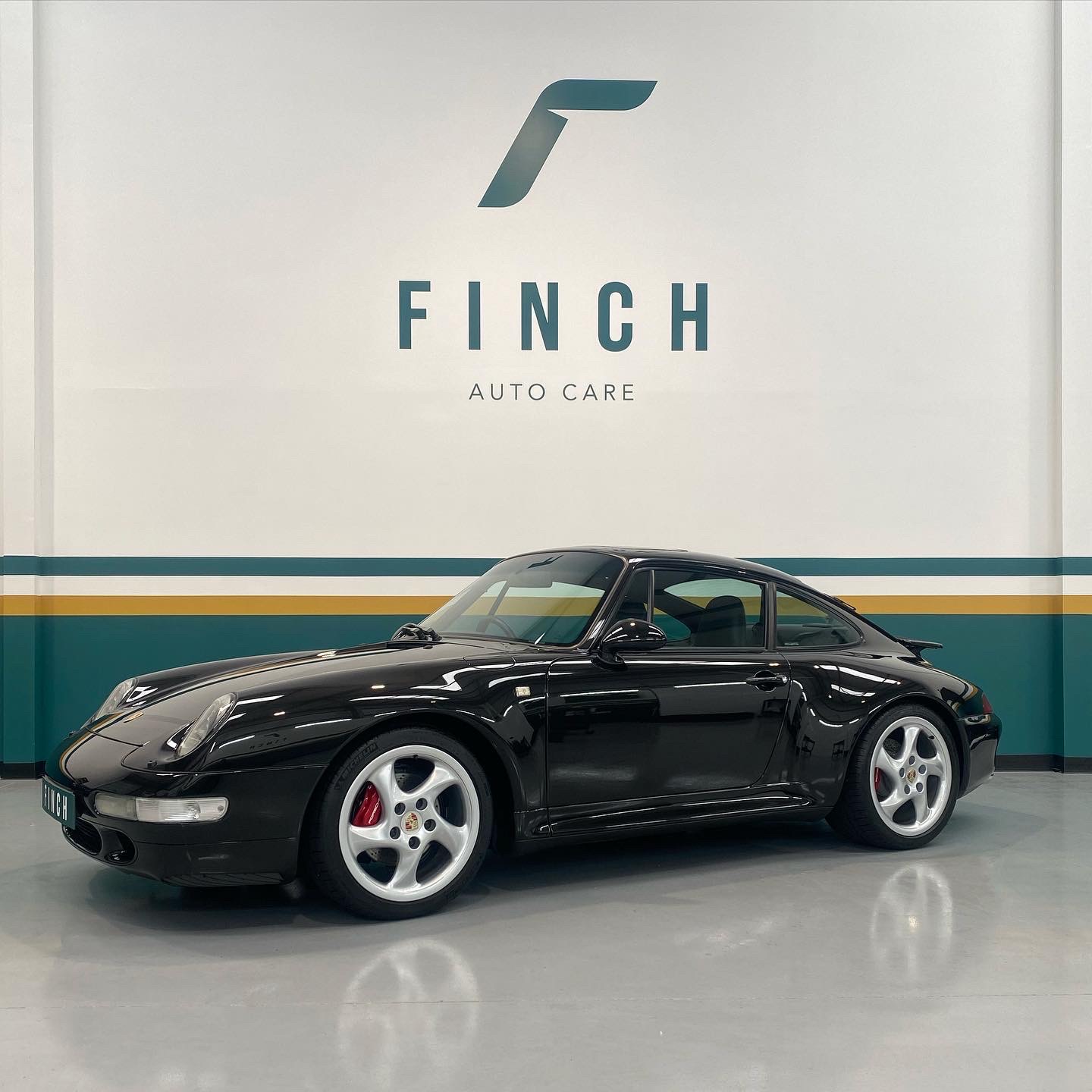 Black porsche 911 displayed at finch auto care.